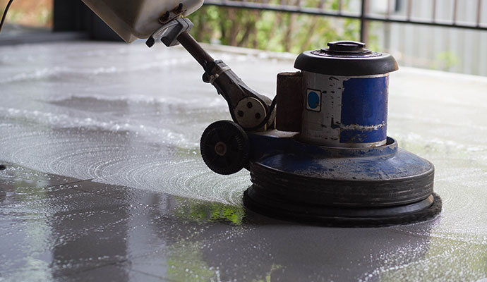 Concrete floor cleaning service using equipment