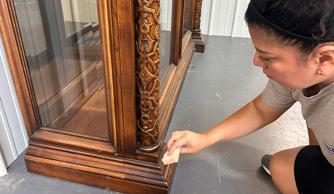 Person cleaning furniture.
