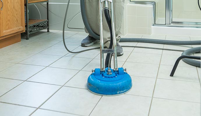 Skilled cleaner using machine to polish and clean tile floor