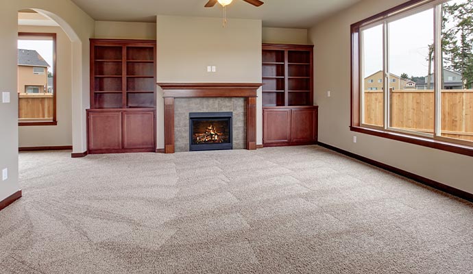 empty living room with a clean beige carpeting