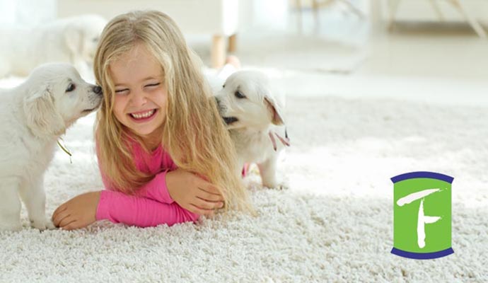 kid with pet on carpet