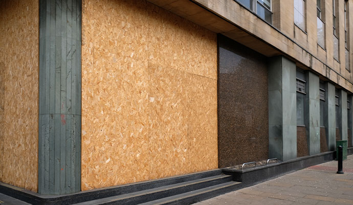 Boarded-up storefront windows on commercial building