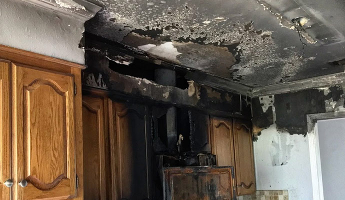 A ceiling severely damaged by fire