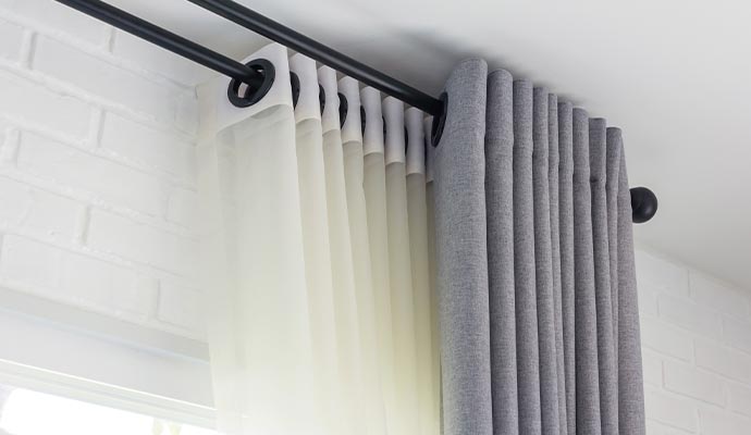 Layered curtains with pleated folds