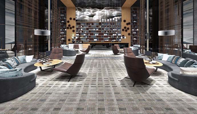 Modern hotel lobby lounge with sofas, chairs, and patterned carpet after odor removal service