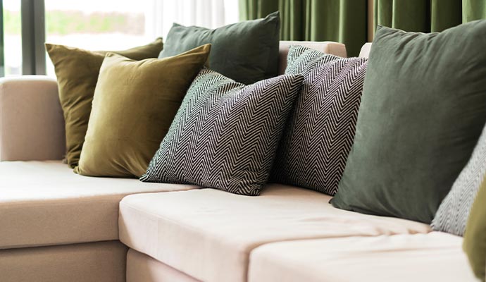 Patterned and solid throw pillows arranged on couch