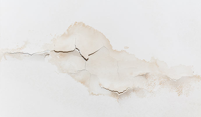 Visible water stains and peeling paint in drywall