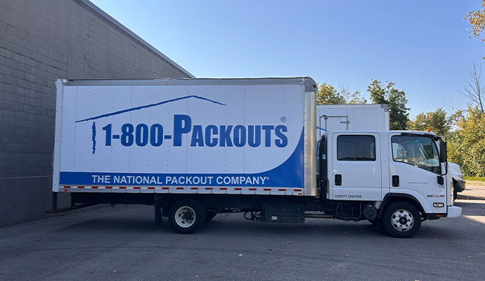 Contents pack out service truck parked outside building