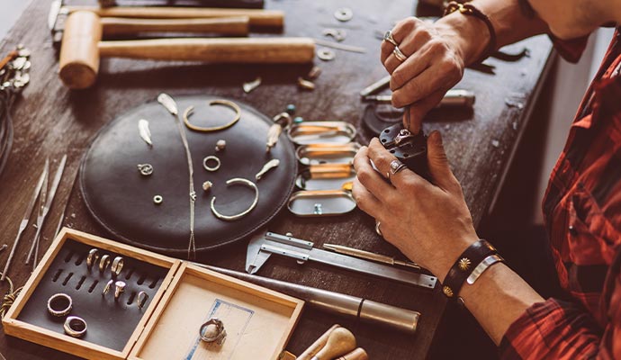 Person restoring jewelry, including rings and bracelets