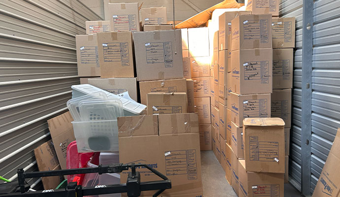 Stacked cardboard boxes in pack out storage unit