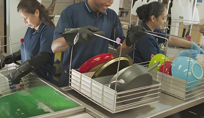 Team of experts cleaning kitchen dishes in a residential house