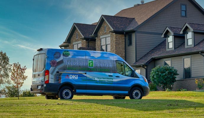 Teasdale Fenton service vehicle parked in front of a residential house