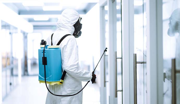 Technician sanitizing the door