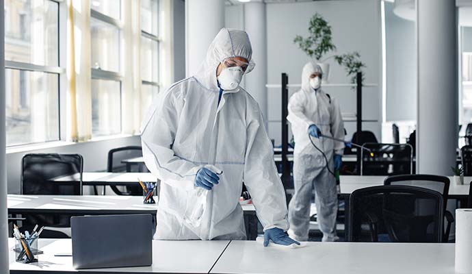 Two experts disinfecting the workplace