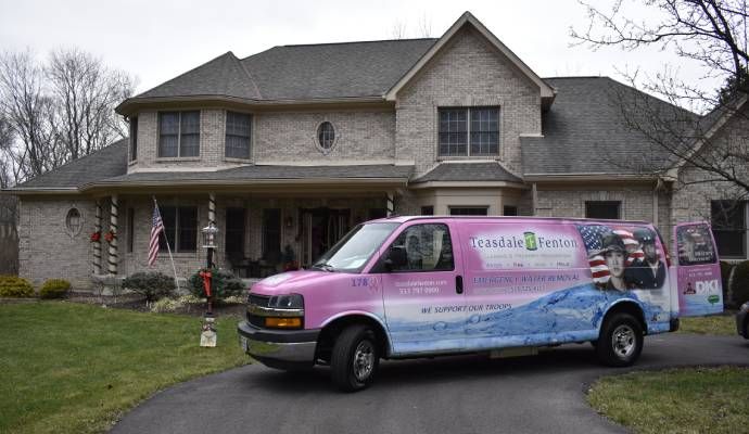 Teasdale Fenton service vehicle parked in front of a house