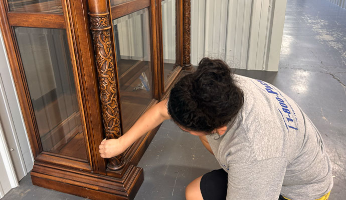 Technician inspecting wooden cabinet