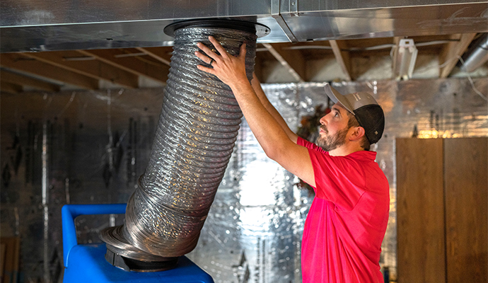 Worker working with duct system