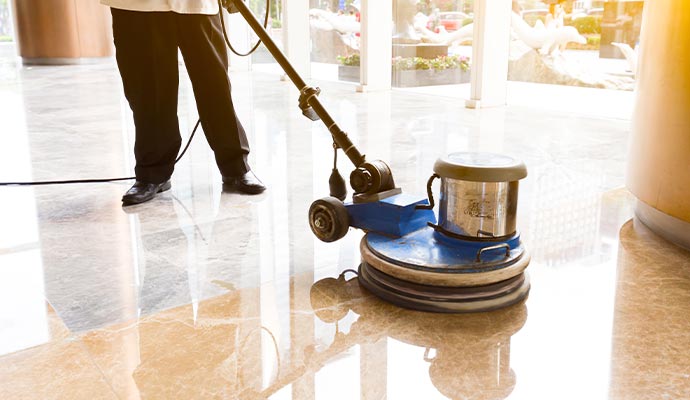 Professional worker polishing marble floor